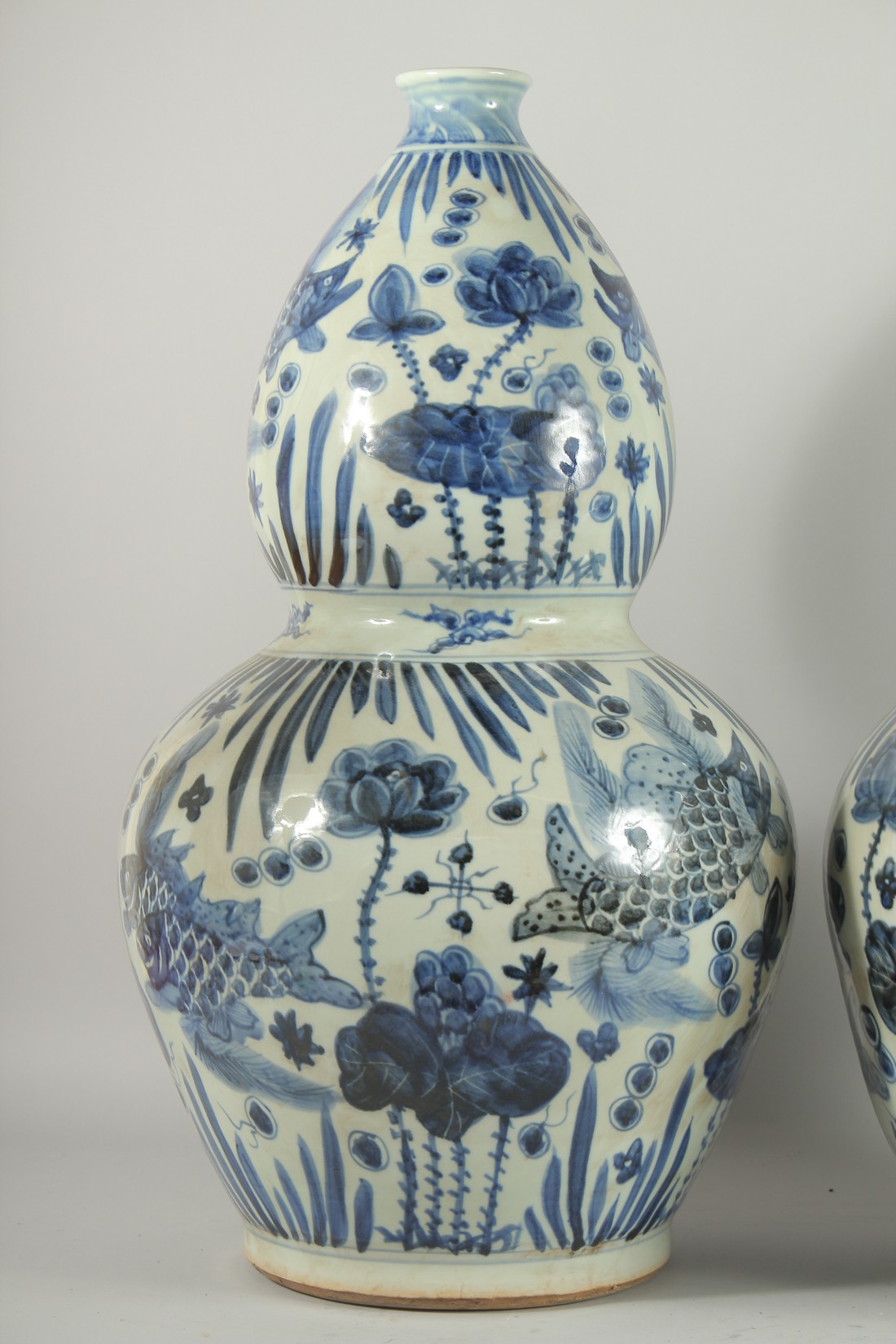 A GOOD PAIR OF CHINESE BLUE AND WHITE PORCELAIN GOURD VASES. 24ins high. - Image 2 of 3
