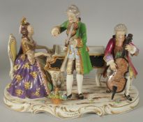 A 20TH CENTURY DRESDEN PORCELAIN GROUP, "THE MUSIC RECITAL". 11ins long.