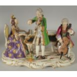 A 20TH CENTURY DRESDEN PORCELAIN GROUP, "THE MUSIC RECITAL". 11ins long.