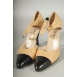 A PAIR OF CHANEL BEIGE AND BLACK LEATHER SLING BACK SHOES. Size 39 boxed.