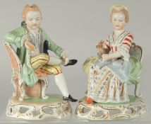 A PAIR OF SITZENDORF PORCELAIN FIGURES of a young man sitting legs crossed and a young lady. 5.