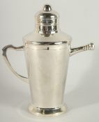 A SILVER PLATED COCKTAIL SHAKER with handle. 11ins high.