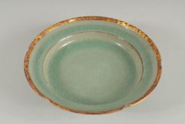 A CHINESE CELADON PETAL FORM DISH with gilt characters to base. 20cm diameter.