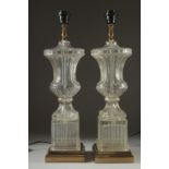 A PAIR OF GLASS URN LAMPS on square bases. 24ins high.