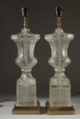 A PAIR OF GLASS URN LAMPS on square bases. 24ins high.