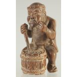 A WOODEN MAN PLAYING A DRUM. 2ins.