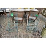 A pair of wrought iron folding chairs.