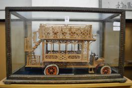 A handmade model of an Omnibus in a display case.