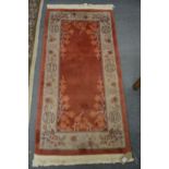 A Chinese rug 145cm x 70cm.