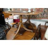 A mahogany twin pillar extending dining table with one leaf.