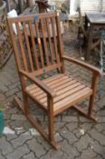 A modern hardwood rocking armchair.