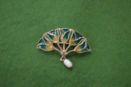A small silver and enamel brooch.