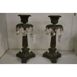 A pair of 19th century classical bronze candle lustres.