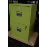 A lime green two drawer metal filing cabinet.