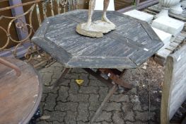 A folding octagonal shaped garden table.