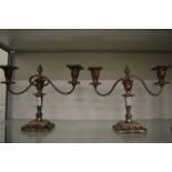 A pair of plated candelabra.