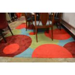 A large colourful abstract design rug 312cm x 202cm.