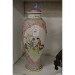 A Chinese famille rose baluster shaped vase and cover (rim damaged).