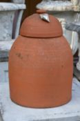 A terracotta rhubarb forcer with cover.