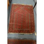 A small Persian prayer rug 106cm x 78cm.