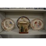 A pair of amusing French pottery plates, Doulton pottery jug 'Oliver Asks For More' and a