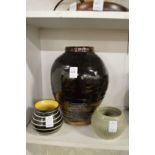 A large studio pottery vase and two smaller studio pottery bowls.