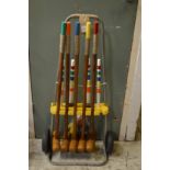 A croquet set on wheeled stand.