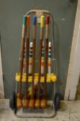 A croquet set on wheeled stand.