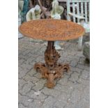 A highly ornate circular cast iron table with ornate base (faults).