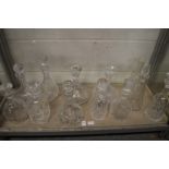 A good collection of cut glass decanters.