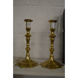 A pair of Georgian style petal base brass candlesticks.