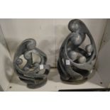 Two modern sculptures depicting family group.