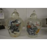 A pair of large reverse painted Chinese glass snuff bottles.