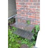A wrought iron three tier plant stand.
