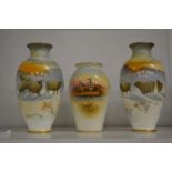A pair of small Royal Doulton vases decorated with sheep in a snowy landscape together with a
