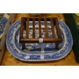 Small wooden stand and a large blue and white willow pattern meat plate.