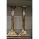 A pair of plated classical column style candlesticks.