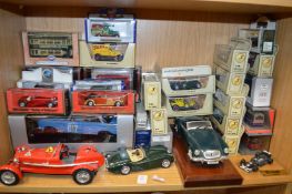A collection of model cars, mostly boxed.