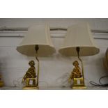 A pair of decorative gilt metal figural table lamps.