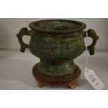 A small Chinese bronze censer on stand.