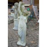 A garden statue modelled as a classical female figure carrying an urn.