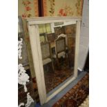 A large over mantel mirror with painted frame.