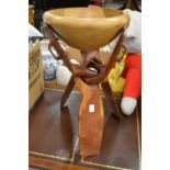 An African hardwood bowl on folding stand.