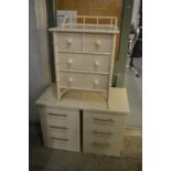 A faux bamboo white lacquer small chest of drawers and a pair of modern three drawer bedside