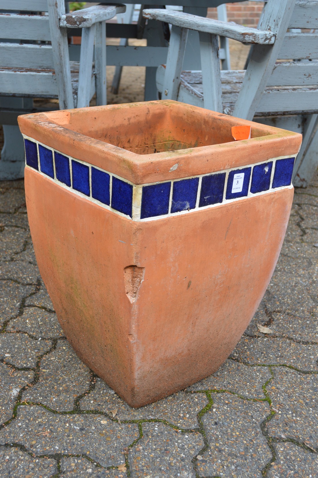A large square shaped terracotta plant pot.