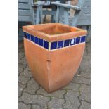 A large square shaped terracotta plant pot.