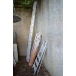 An aluminium two section ladder, a wooden three section ladder and a step ladder.