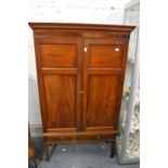 A mahogany cupboard with two doors and one long drawer.