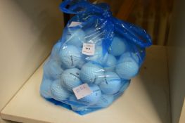 A bag of assorted golf balls.