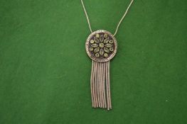 A silver pendant and chain.